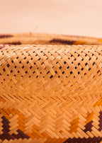 Cesto de fibras bege, marrom e amarelo feito por artesãs do Teçume da Amazônia, artesanato indígena brasileiro 
