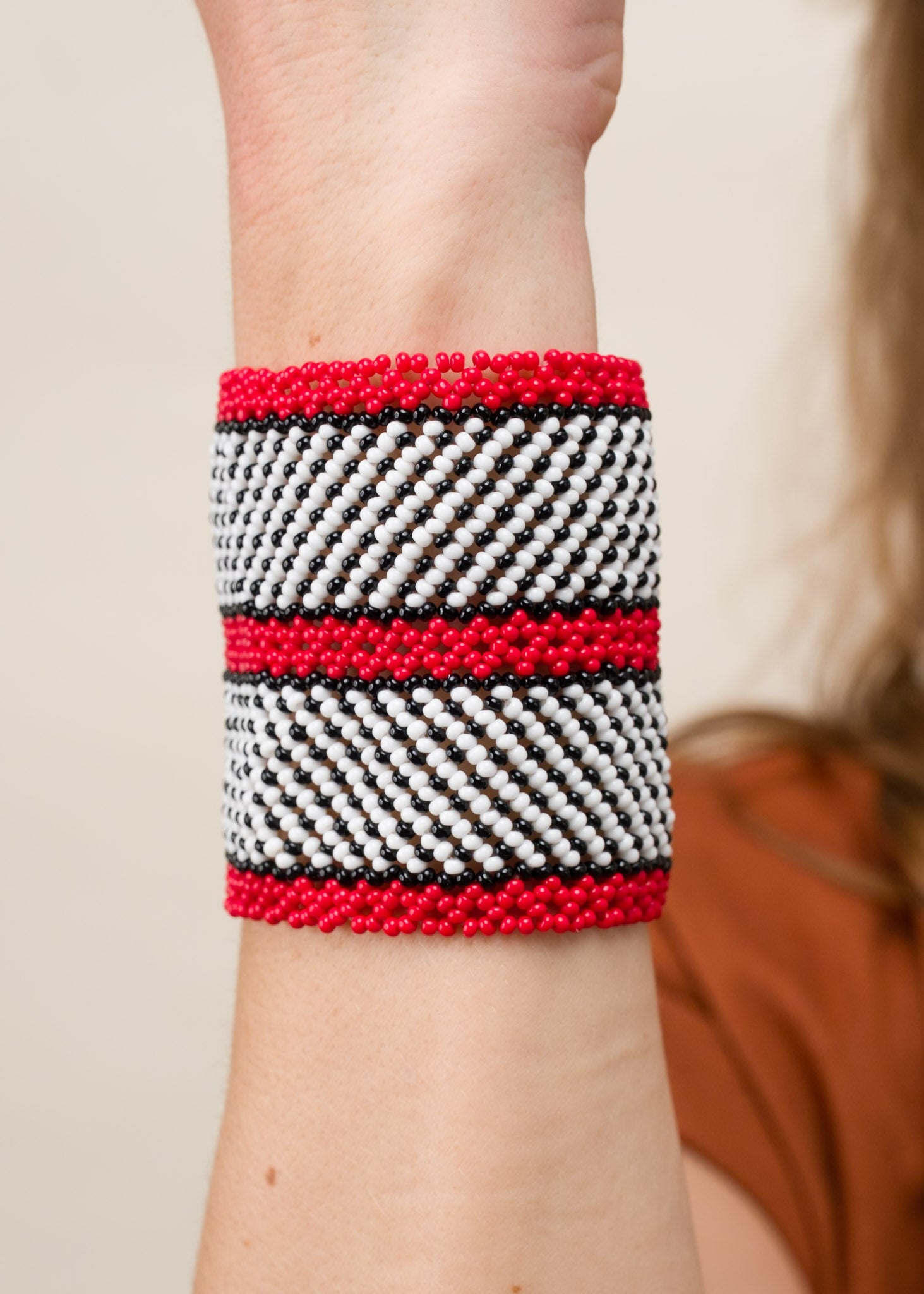 Pulseira de miçangas branca e vermelha feita pelo povo Waurá, artesanato indígena brasileiro